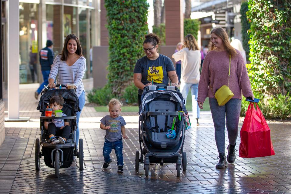 Carina Inganamort, Sophie Aronfeld and Chelsea Aronfeld walk with their children while doing some Black Friday shopping at Tempe Marketplace on Nov. 26, 2021.