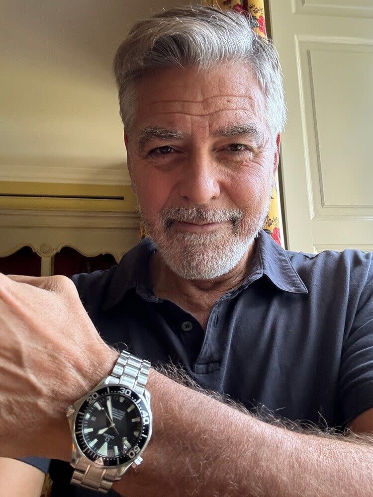 Clooney and his watch. <em>(HFOT via eBay)</em>