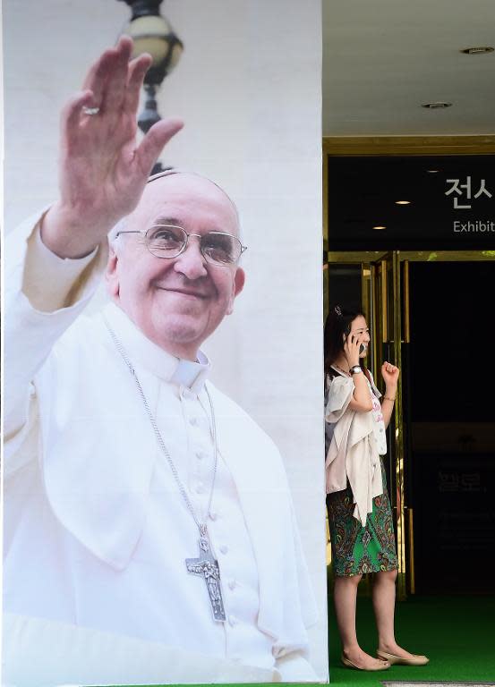 A poster advertises a Pope Francis photo exhibition is displayed in Seoul on August 8, 2014