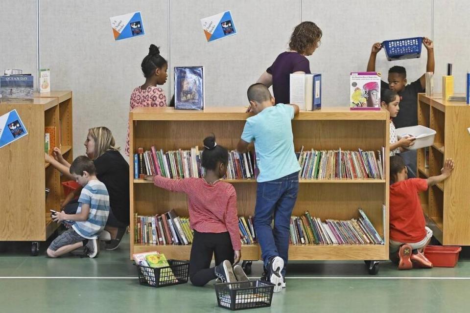 Third graders search for books during the WAKE Up and Read event in Garner, N.C., Thursday, May 11, 2017.
