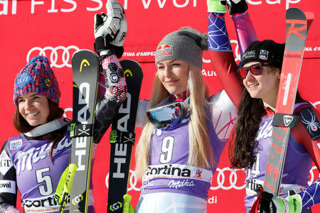 Skiing - Alpine Skiing World Cup - Women's Downhill - Cortina d'Ampezzo, Italy - January 20, 2018. Tina Weirather (L), Lindsey Vonn (C) and Jacqueline Wiles celebrate on the podium. REUTERS/Stefano Rellandini