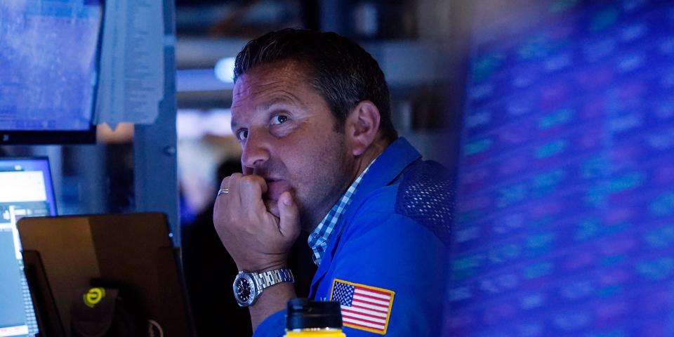 A trader sits in front of a computer monitor on the floor of the New York Stock Exchange.