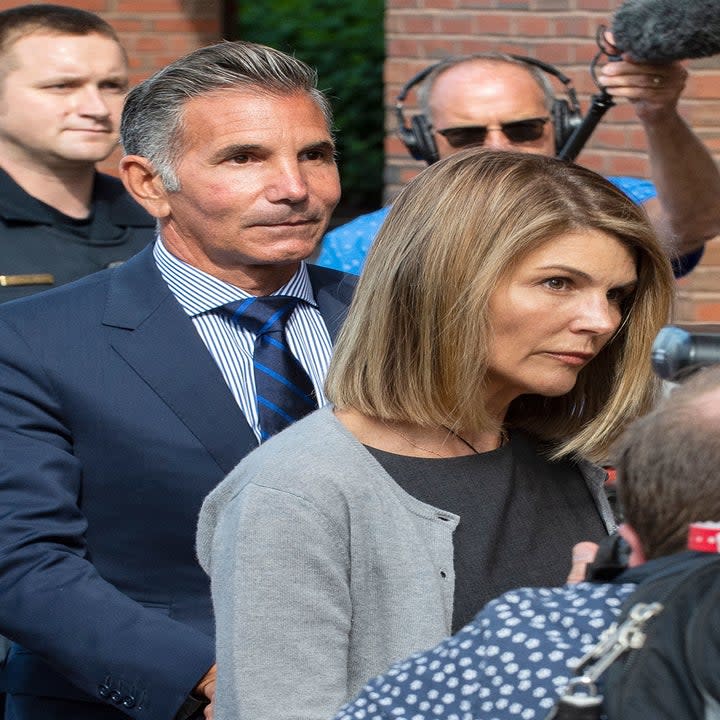 Lori Loughlin and husband Mossimo Giannulli exit the Boston Federal Court house after a pre-trial hearing in Boston in 2019