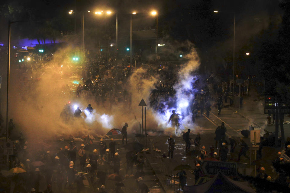 Police try to clear protesters with tear gas outside the Legislative Council in Hong Kong, during the early hours of Tuesday, July 2, 2019. Hundreds of protesters in Hong Kong swarmed into the legislature's main building Monday night, tearing down portraits of legislative leaders and spray-painting pro-democracy slogans on the walls of the main chamber as frustration over a lack of response from the administration to opposition demands boiled over. (Jeff Cheng/HK01 via AP) HONG KONG OUT, NO ARCHIVE