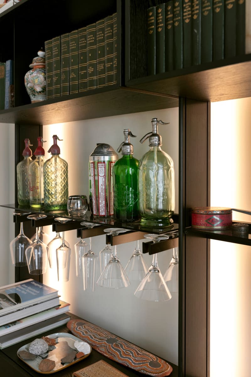 Built in bar with back lighting and wood holders for stemmed glasses