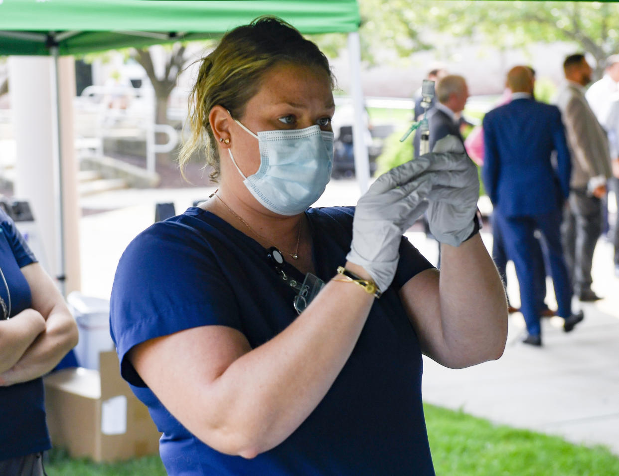 Joy Platchek, RN, BSN, with the Berks Community Health Center fills a syringe with a dose of BioNTech, Pfizer COVID-19 vaccine. (Ben Hasty/MediaNews Group/Reading Eagle via Getty Images)