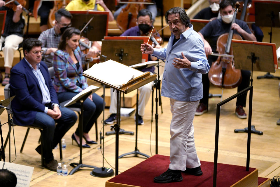 Italian conductor Riccardo Muti, 80, right, baritone Luca Salsi, left, and soprano Joyce El-Khoury, seated second right, rehearses Verdi's "Un Ballo in Maschera (A Masked Ball)" with the Chicago Symphony Orchestra in Chicago on Wednesday, June 22, 2022. Muti, whose Chicago contract runs through the 2022-23 season, considers himself the descendant of strong Italian conductors reaching back to Arturo Toscanini and Tulio Serafin. (AP Photo/Nam Y. Huh)