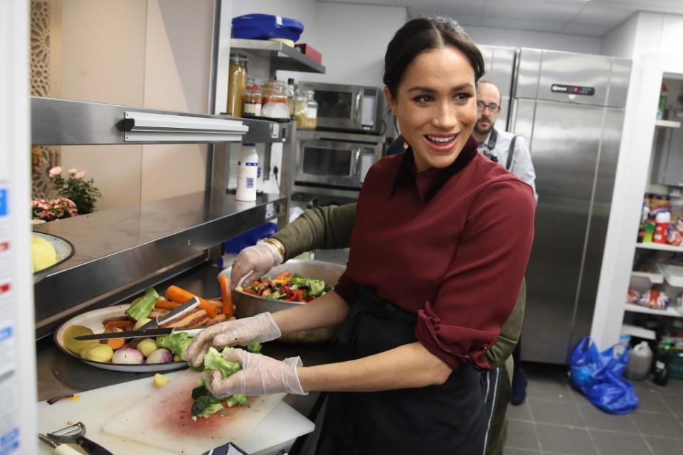 Meghan Markle will host a cooking show on Netflix. Here, she helps out the the Hubb Community Kitchen in London in 2018. POOL/AFP via Getty Images