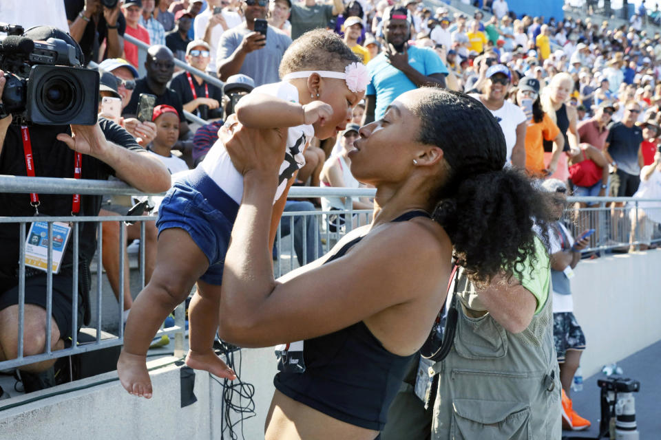FILE - In this July 27, 2019, file photo, Allyson Felix holds her daughter Camryn after running the women's 400-meter dash final at the U.S. Championships athletics meet in Des Moines, Iowa. Early in her career, Allyson Felix would shy away from speaking on controversial subjects. The nine-time Olympic medalist stayed in her lane. Not anymore. Not since the birth of her daughter, Camryn. Felix wants her legacy to be improving maternity rights for athletes over her times and gold medals. "I feel like I'm right where I'm supposed to be," Felix said. "I feel stronger than ever, just with everything I've been through.”(AP Photo/Charlie Neibergall, File)