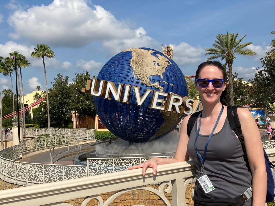 Lisa Galek smiling in front of Universal Orlando globe