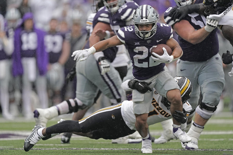 Kansas State running back Deuce Vaughn (22) gets past Missouri defensive back Jaylon Carlies (1) as he runs the ball during the second half of an NCAA college football game Saturday, Sept. 10, 2022, in Manhattan, Kan. (AP Photo/Charlie Riedel)