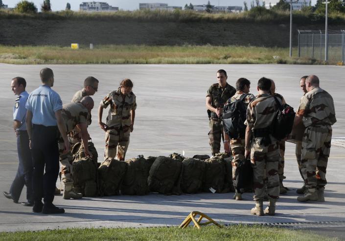 Investigators from the French Air Transport Gendarmerie and the French Criminal Analysis Unit gather their gear on July 25, 2014 at Velizy-Villacoublay's military airport before leaving for the crash site of Air Algerie flight AH5017 in Mali (AFP Photo/Francois Guillot)