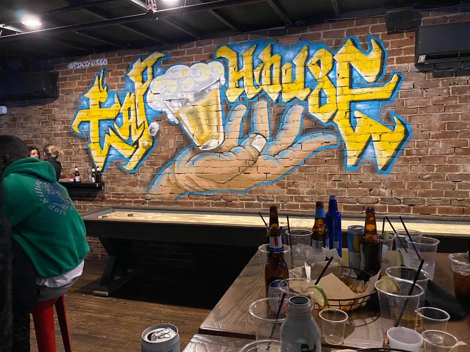 A blue and gold "Tap House" mural was added above a new full-size shuffleboard table in the middle room that connects Catherine Rooney's and Trolley Tap House in Wilmington.