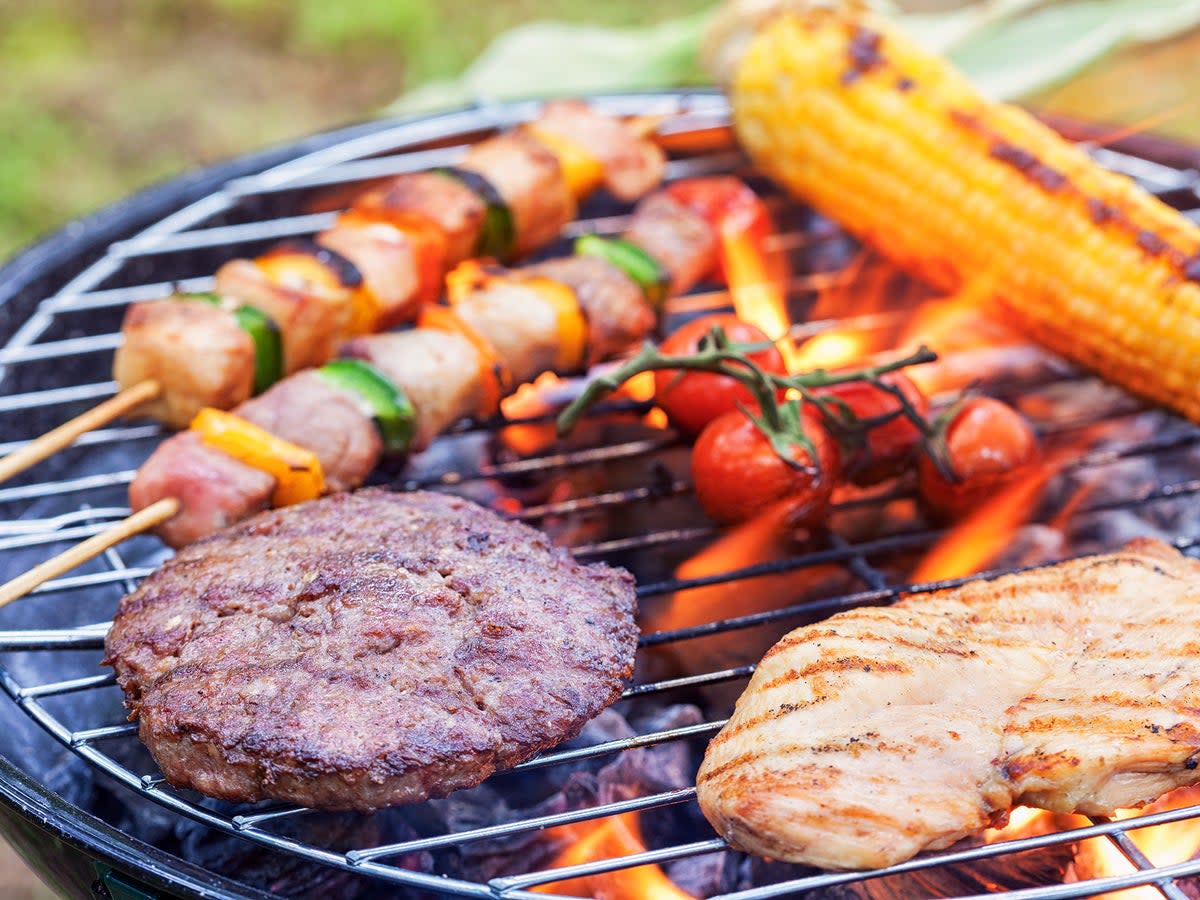 Prearing meat and vegetables on a BBQ   (Getty)