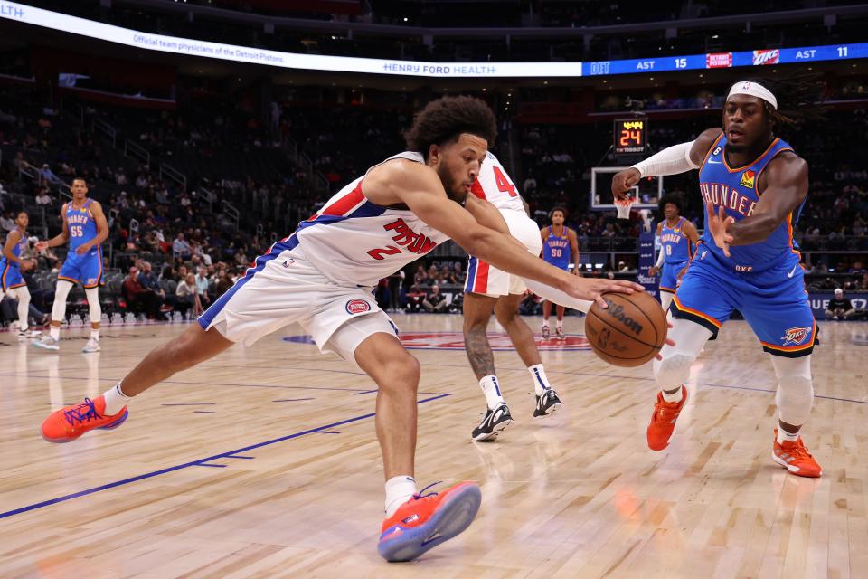 Pistons guard Cade Cunningham battles for the ball against Thunder forward Luguentz Dort during the first half of the preseason game on Tuesday, Oct. 11, 2022, at Little Caesars Arena.