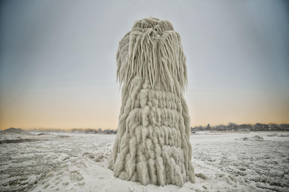 SOUTH HAVEN, MI - JANUARY 8: Ice covers the South Pierhead Light, on January 8, 2015, in South Haven, Michigan.ICE engulfs a red lighthouse as a fierce winter storm grips South Haven, Michigan. Sharp icicles and surreal formations can be seen hanging from the railings after strong waves crashed onto the piers. After each coating the water quickly freezes to ice and the pier is transformed into a slippery, white wonderland. Weather in the area dipped into the minus figures and froze over Lake Michigan in the beginning of January.PHOTOGRAPH BY Mike Kline / Barcroft MediaUK Office, London.T +44 845 370 2233W www.barcroftmedia.comUSA Office, New York City.T +1 212 796 2458W www.barcroftusa.comIndian Office, Delhi.T +91 11 4053 2429W www.barcroftindia.com