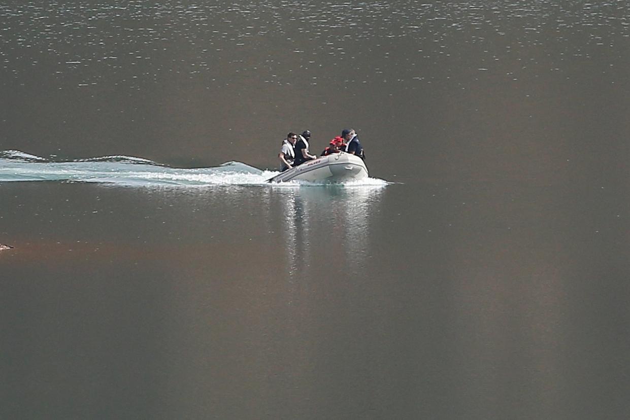 A search dingy navigates in the Arade dam near Silves, Portugal (AP)