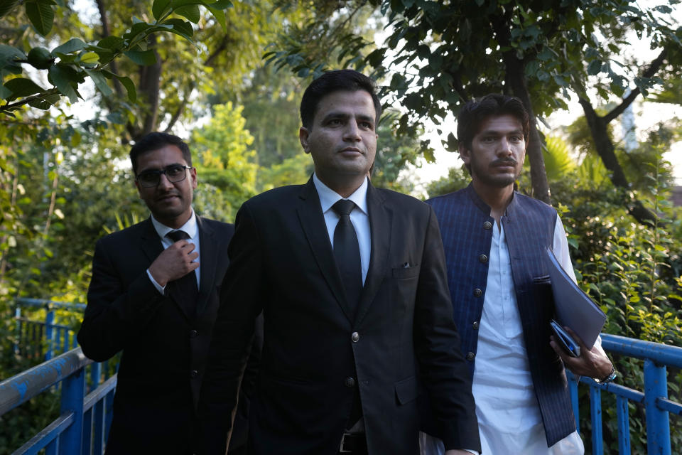 Naeem Haider Panjutha, center, a lawyer of Pakistan's former Prime Minister Imran Khan, arrives with others for a press conference after meeting with Khan in Islamabad, Pakistan, Monday, Aug. 7, 2023. Khan is now an inmate at a high-security prison after being convicted of corruption and sentenced to three years. (AP Photo/Anjum Naveed)