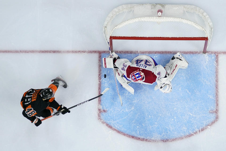 Montreal Canadiens' Jake Allen (34) blocks a shot by Philadelphia Flyers' Morgan Frost (48) during the second period of an NHL hockey game, Friday, Feb. 24, 2023, in Philadelphia. (AP Photo/Matt Slocum)