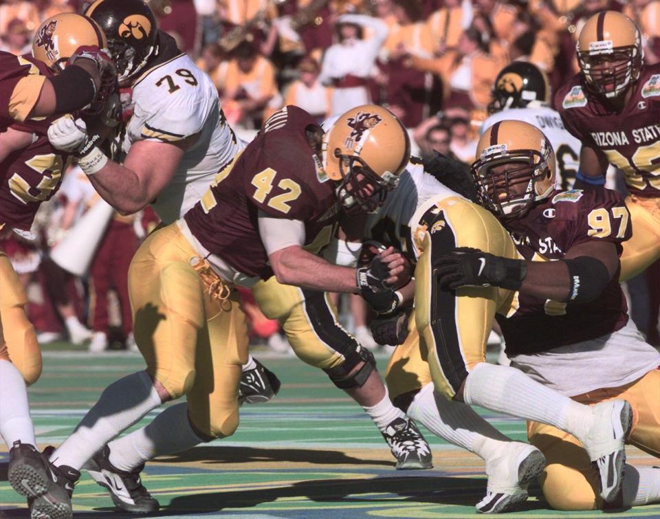 ASU's Pat Tillman and Albrey Battle tackle Iowa's Tim Dwight during 1997 Sun Bowl.