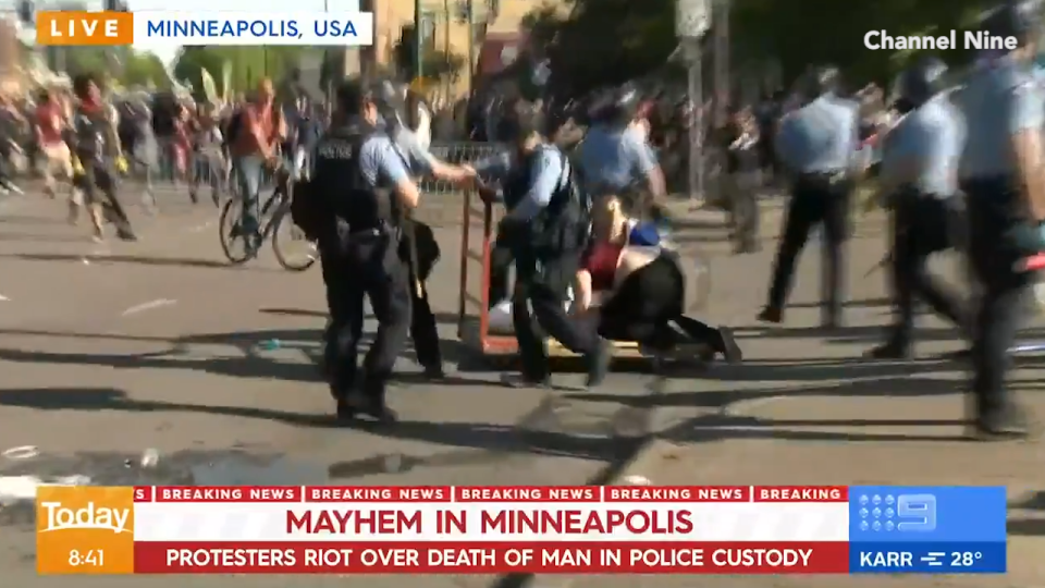 Police officers on the scene of protests in Minneapolis, US.