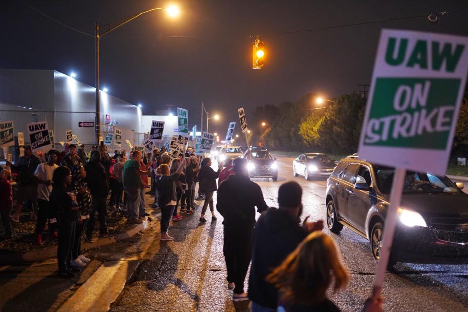 Workers leave Flint Assembly plant in Flint, Michigan, early Monday, Sept. 16, 2019, while taking part in a national strike against General Motors after stalled contract negotiations with General Motors. The workers are on the first national UAW strike since 2007.