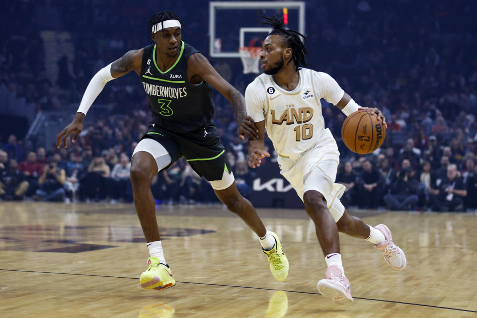 Cleveland Cavaliers guard Darius Garland (10) drives against Minnesota Timberwolves forward Jaden McDaniels (3) during the first half of an NBA basketball game, Sunday, Nov. 13, 2022, in Cleveland. (AP Photo/Ron Schwane)