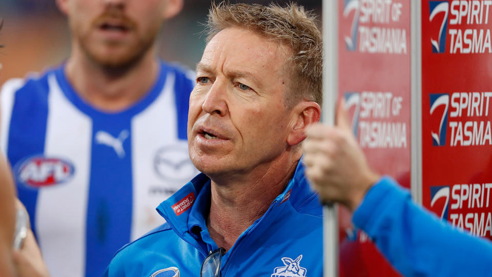 David Noble gives instructions to the Kangaroos during a huddle.