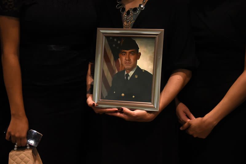 Mourners attend a funeral for a Texas man who died of COVID-19