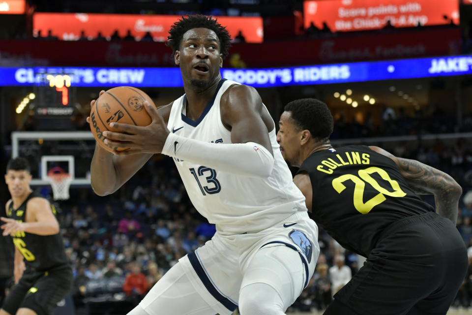 Memphis Grizzlies forward Jaren Jackson Jr. (13) handles the ball against Utah Jazz forward John Collins (20) in the second half of an NBA basketball game Wednesday, Nov. 29, 2023, in Memphis, Tenn. (AP Photo/Brandon Dill)