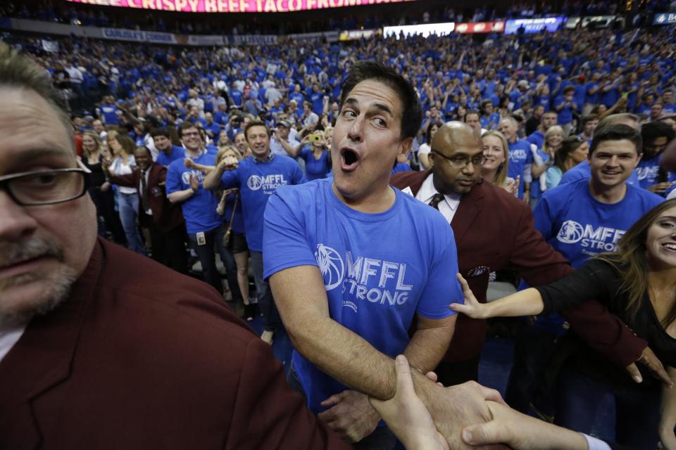 Dallas Mavericks owner Mark Cuban is congratulated after after his team's 109-108 win over the San Antonio Spurs in Game 3 in the first round of the NBA basketball playoffs in Dallas, Saturday, April 26, 2014. The(AP Photo/LM Otero)