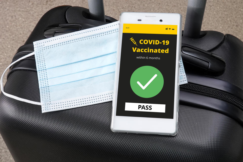 Smartphone with digital vaccination certificate for COVID-19 on a luggage.