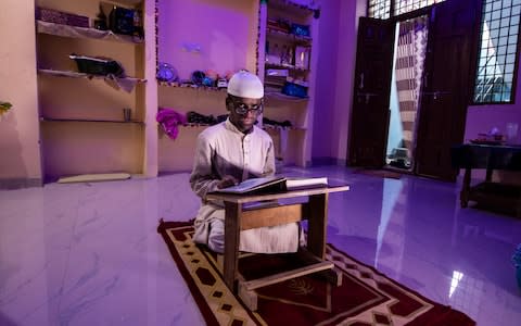 Anwar Uddin who has had corneal transplants as a result of XP. He could only go outside for a brief period before feeling unwell. As a result of the transplants he can now read and now has a new role teaching Arabic and the Koran - Credit: Simon Townsley/The Telegraph