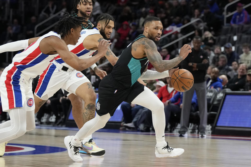 Portland Trail Blazers guard Damian Lillard brings the ball up court during the first half of an NBA basketball game against the Detroit Pistons, Monday, March 6, 2023, in Detroit. (AP Photo/Carlos Osorio)