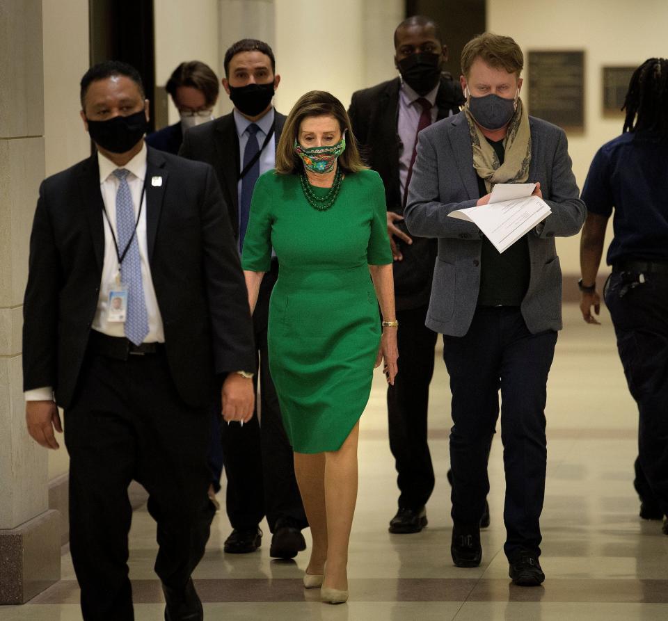 Speaker of the House Nancy Pelosi (D-Calif.) walks to a news conference Friday about the COVID-19 financial relief package and the proposal to increase the federal minimum wage to $15 an hour. (Photo: BRENDAN SMIALOWSKI/AFP via Getty Images)