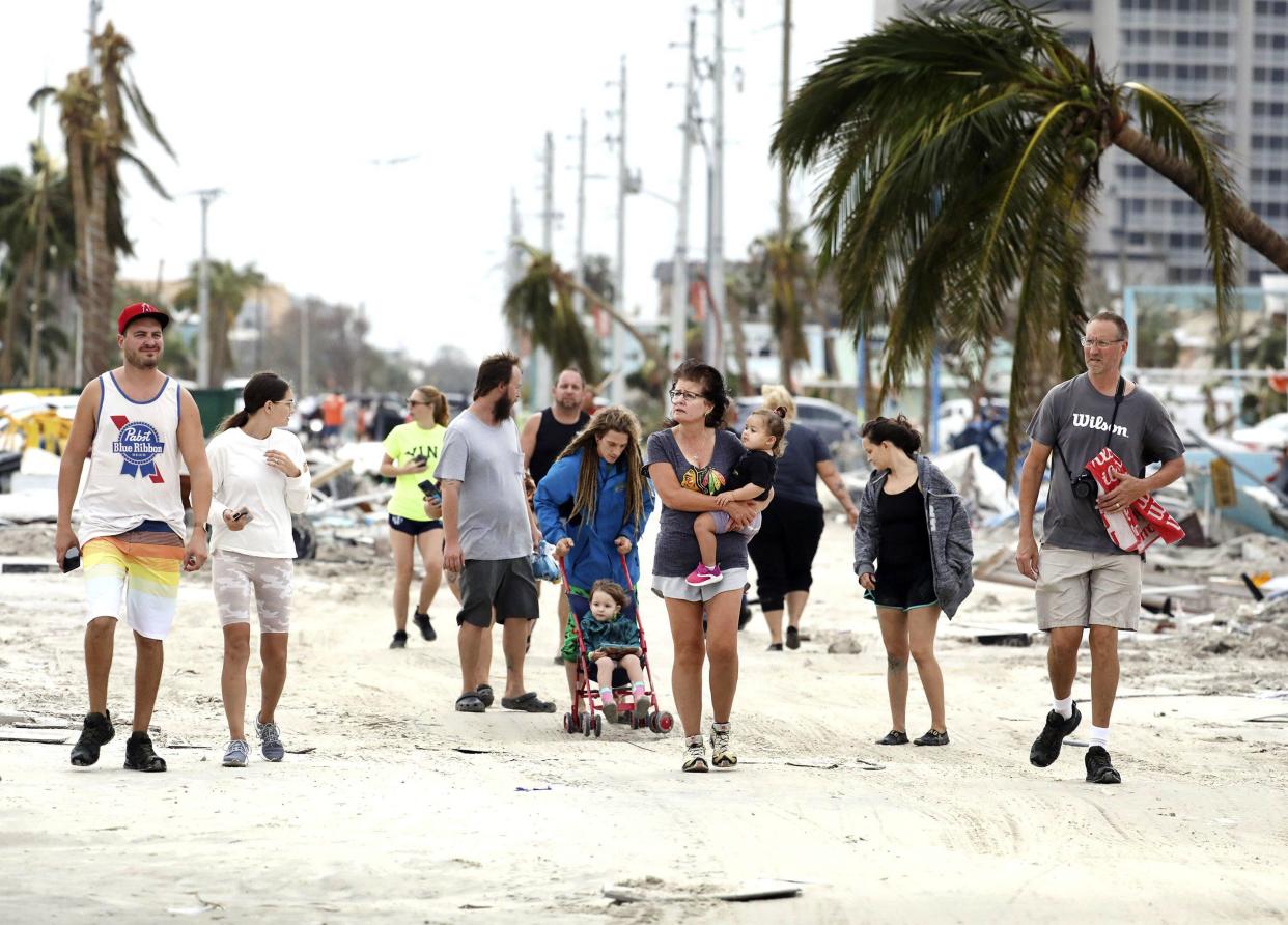 Residents explore damage in Fort Myers Beach, Fla., on Thursday, Sep 29, 2022, following Hurricane Ian.