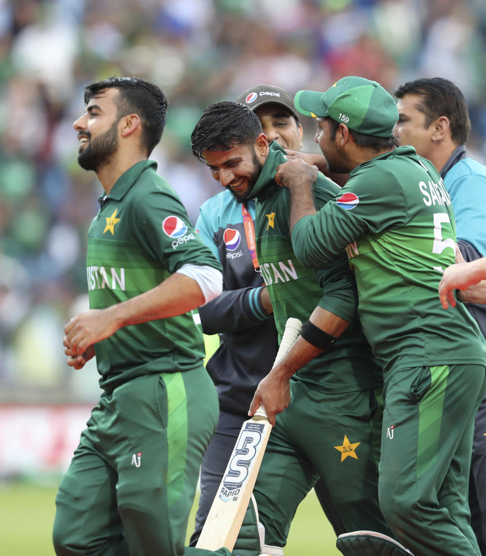 Pakistani cricketers celebrate their team's victory in the Cricket World Cup match between Pakistan and Afghanistan at Headingley in Leeds, England, Saturday, June 29, 2019. (AP Photo/Rui Vieira)