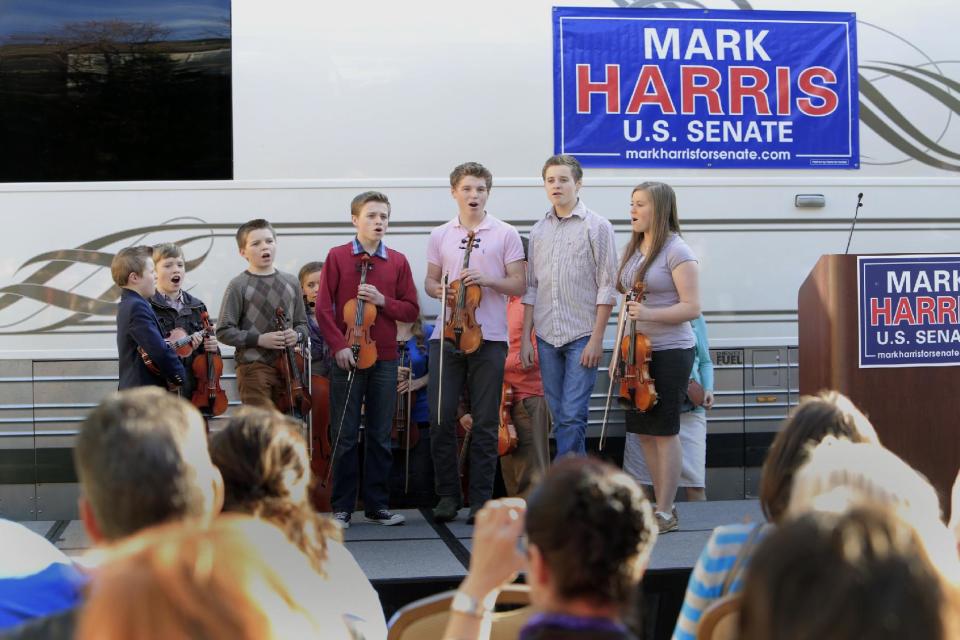 FILE - In this March 14, 2014 file photo, children from the Duggar family sing during a campaign event for Rev. Mark Harris, who is seeking a Republican U.S. Senate nomination in the upcoming North Carolina primary, in Raleigh, N.C., The Duggars, with 19 children in all, star in a reality TV show. (AP Photo/Ted Richardson)