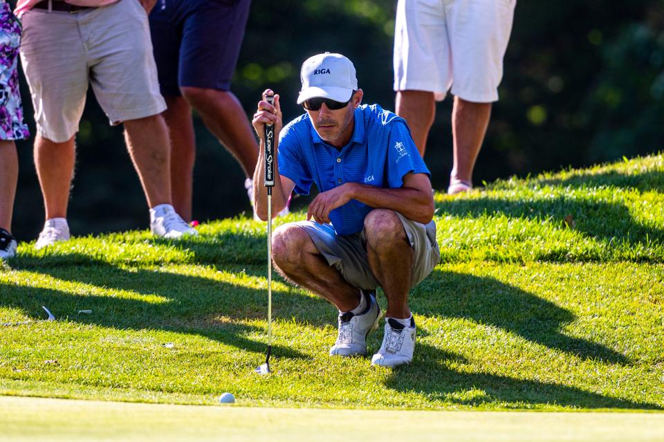 Kevin Silva studies the 18th green at the CCNB Fourball Tournament Finals.