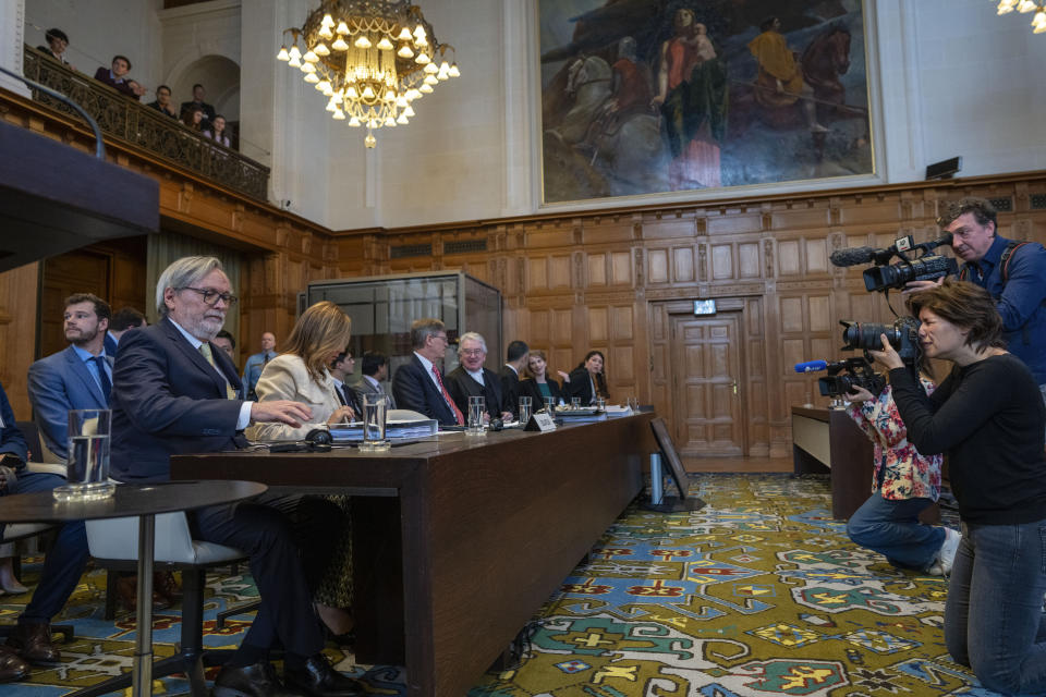 Ecuador's ambassador Andres Teran Parral, left, and agent Ana Maria Larrea, second left, wait for judges to enter the International Court of Justice, or World Court, in The Hague, Netherlands, Wednesday, May 1, 2024. Mexico is taking Ecuador to the United Nations' top court on Tuesday accusing the nation of violating international law by storming into the Mexican embassy in Quito on April 5, and arresting former Ecuador Vice President Jorge Glas, who had been holed up there seeking asylum in Mexico. (AP Photo/Peter Dejong)