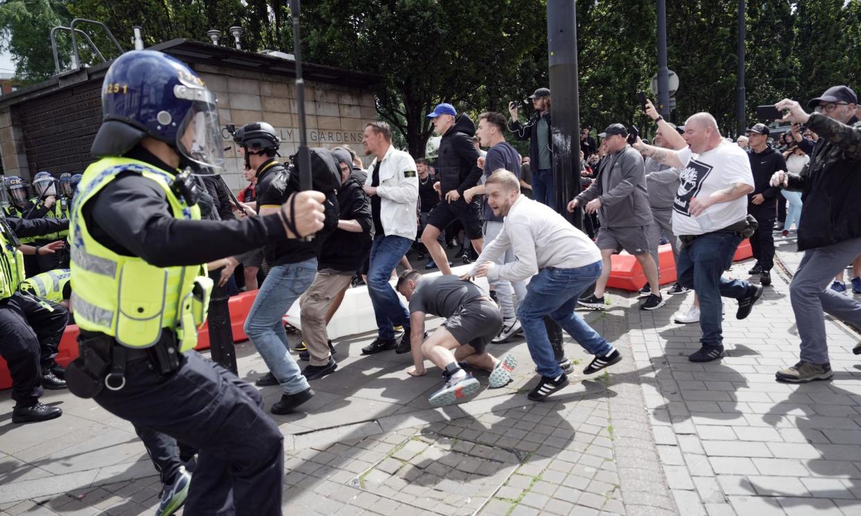 <span>Police clash with right wing protesters in Piccadilly Gardens on 3 August in Manchester.</span><span>Photograph: Christopher Furlong/Getty Images</span>