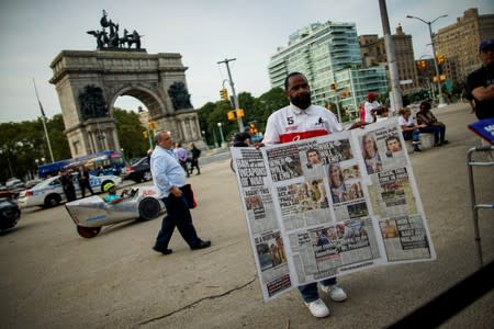 People gather for a vigil to remember victims of the mass shootings at Dayton and El Paso, at Grand Army Plaza in Brooklyn, New York