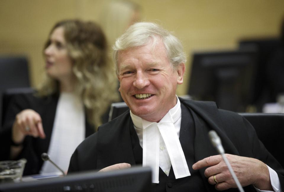 Defence counsel David Hooper awaits the start of a verdict in the courtroom of the International Criminal Court (ICC) in The Hague, Netherlands, Friday March 7, 2014. The ICC has convicted rebel leader Germain Katanga of charges including murder and pillage during a deadly attack on a village in eastern Congo, but acquitted him of rape, sexual slavery and using child soldiers. Katanga showed no emotion as judges convicted him as an accessory in the attack on the strategic village of Bogoro on Feb. 24, 2003, in which some 200 civilians were hacked or shot to death. (AP Photo/Phil Nijhuis, Pool)