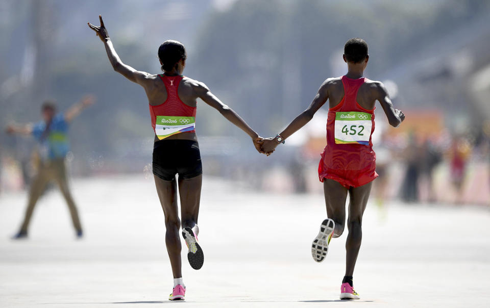 <p>Jemima Sumgong of Kenya and Eunice Jepkirui Kirwa of Bahrain celebrate after the women’s marathon on August 14, 2016. (REUTERS/Dylan Martinez) </p>