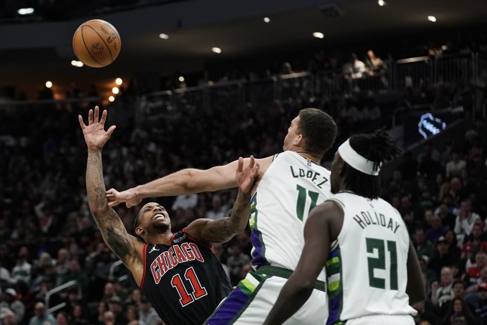 Chicago Bulls' DeMar DeRozan shoots past Milwaukee Bucks' Brook Lopez during the second half of Game 1 of their first round NBA playoff basketball game Sunday, April 17, 2022, in Milwaukee. The Bucks won 93-86 to take a 1-0 lead in the series. (AP Photo/Morry Gash)