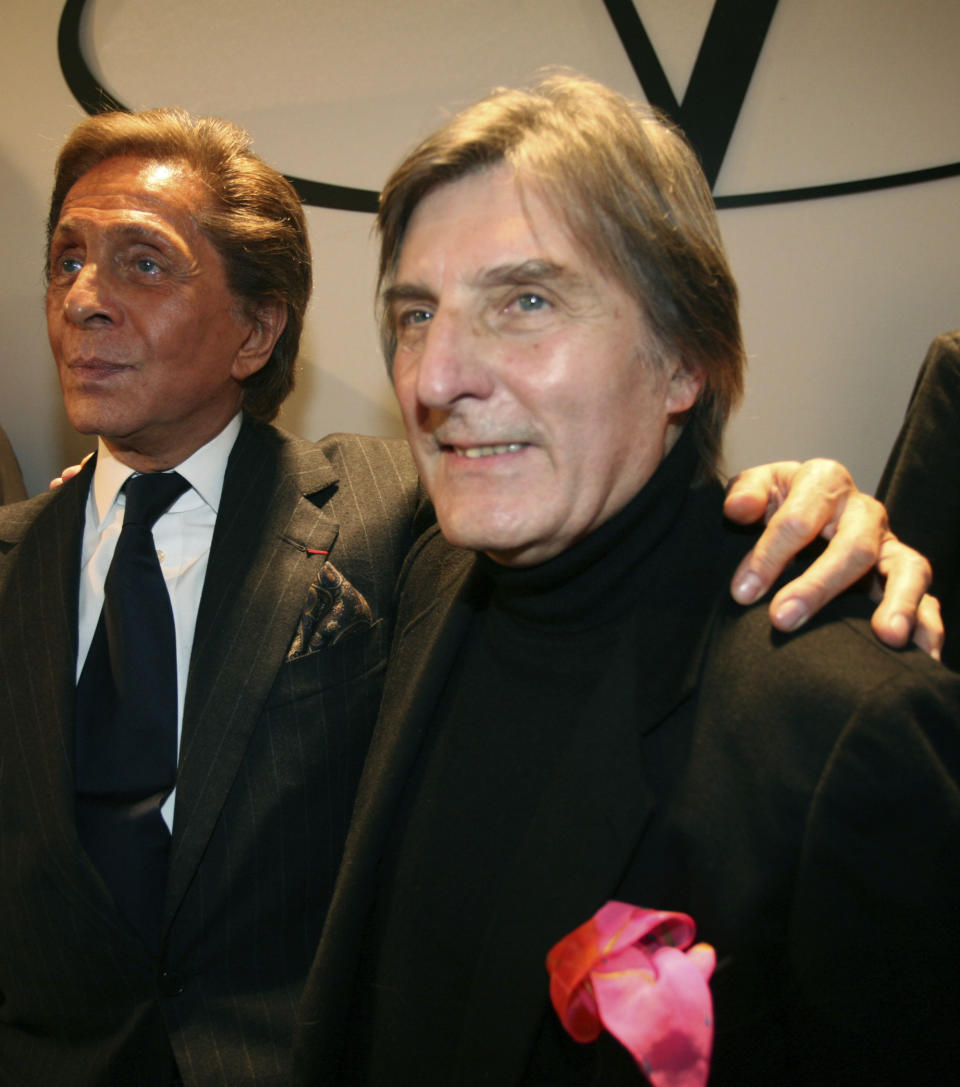 FILE - In this Wednesday, Jan. 23, 2008 file photo, Italian fashion designer Valentino, left, celebrates with French designer Emmanuel Ungaro after the presentation of his Haute Couture Spring-Summer 2008 collection, in Paris. Fashion house Emanuel Ungaro says that French designer Emanuel Ungaro has died at the age of 86. The house posted Sunday, Dec. 22, 2019 on Instagram that Ungaro “will remain in our memories as the Master of sensuality, of color and flamboyance." Ungaro has died on Saturday in Paris, according to French medias. Renowned for his use of vibrant colors, mixed prints and elegant draping, Ungaro founded the house that bears his name in 1965. He retired from fashion in 2004. (AP Photo/Thibault Camus, File)