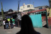 People arrive at the home of seven-year-old Fatima Cecilia Aldrighett, who went missing on February 11 and whose body was discovered over the weekend inside a plastic garbage bag, in Mexico City