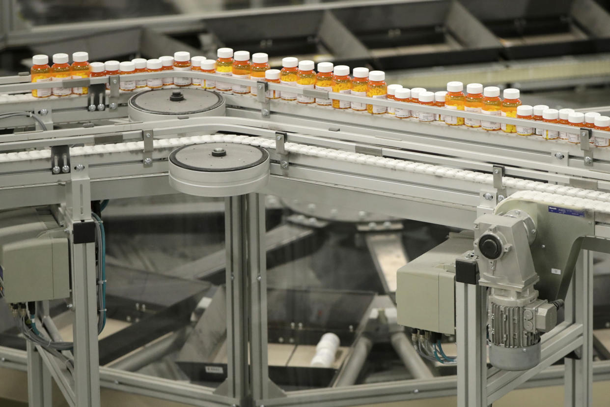 In this July 10, 2018, file photo bottles of medicine ride on a belt at the Express Scripts mail-in pharmacy warehouse in Florence, N.J. (AP Photo/Julio Cortez, File)