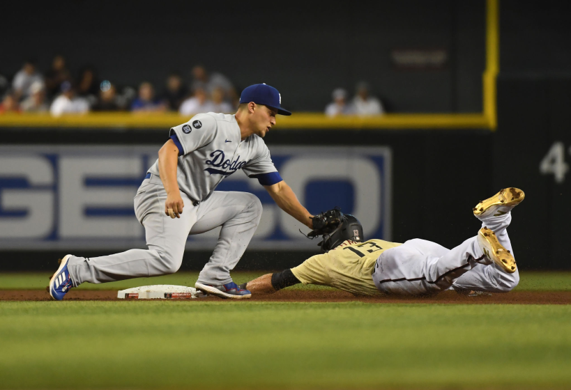 The Diamondbacks' Nick Ahmed steals second base ahead of Dodgers shortstop Corey Seager's tag during the fourth inning.