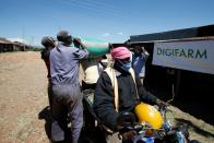 Farmers present their maize harvest at the collection centre facilitated by Safaricom DigiFarm App, that helps agribusinesses and small holding farmers to share information and transact easily, in Sigor village of Bomet County